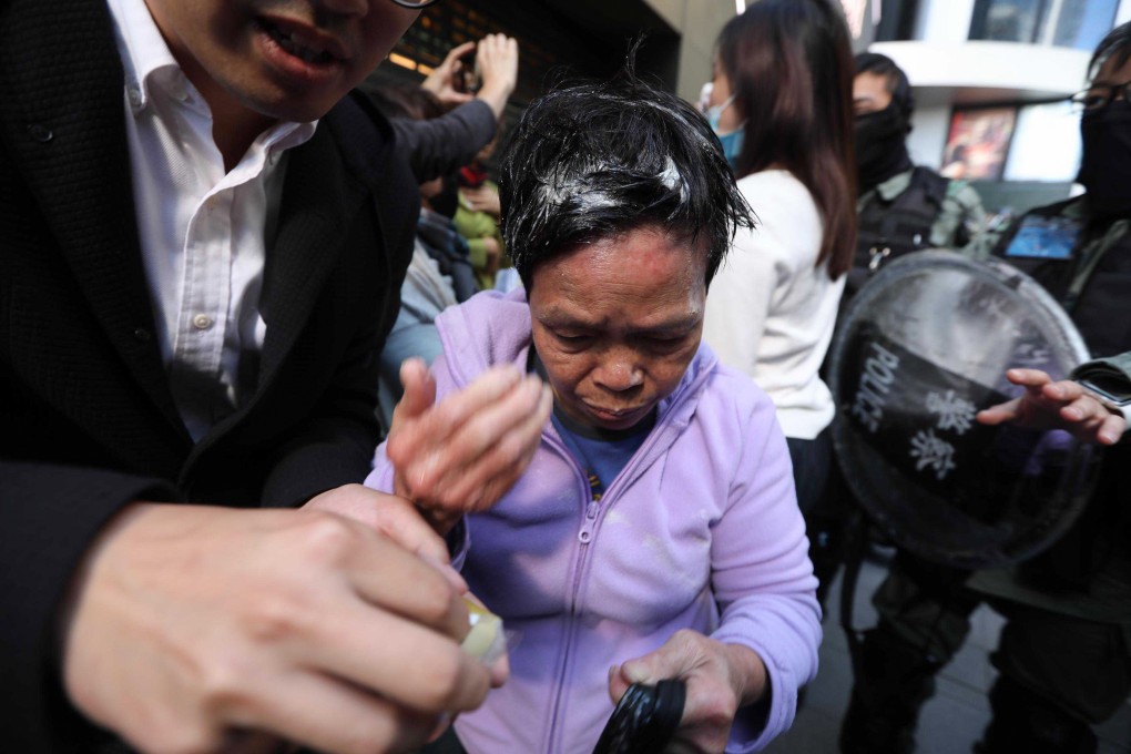 A woman tries to leave Pedder Street in Central after being pepper sprayed by police. Photo: Xiaomei Chen