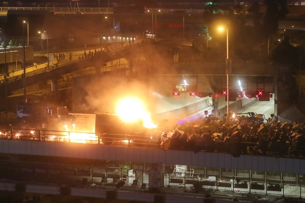A police armoured vehicle has been set on fire by petrol bombs on the Cheong Wan Road flyover during clashes between riot police and students on the bridge of the Cross-Harbour Tunnel besides Hong Kong Polytechnic University in Hung Hom. 17NOV19 SCMP / Sam Tsang