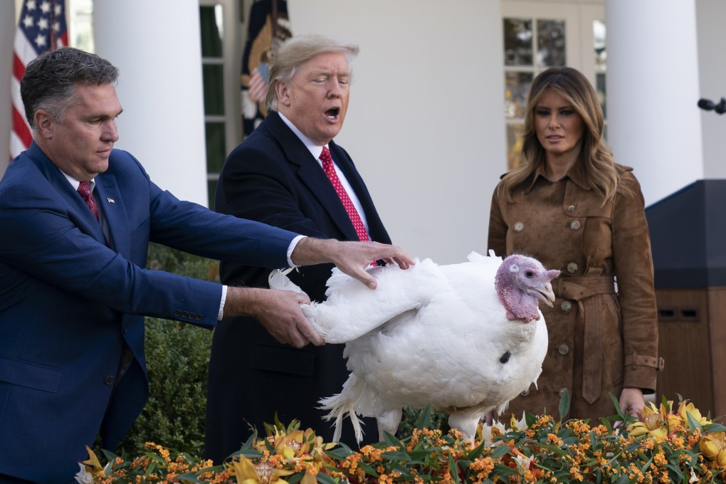 US President Donald Trump pardons a turkey named “Butter” in a Thanksgiving ceremony on November 26, with farmer Wellie Jackson, who raised the bird, and First Lady Melania Trump. Photo: EPA-EFE