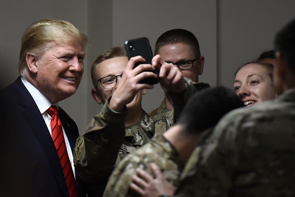 US President Donald Trump poses for selfies during a Thanksgiving dinner with US troops during a surprise visit to Afghanistan on Friday. Photo: AFP