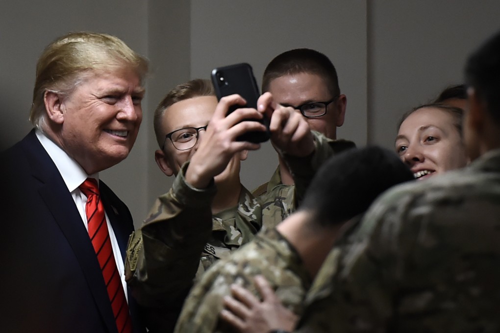 US President Donald Trump poses for selfies during a Thanksgiving dinner with US troops during a surprise visit to Afghanistan on Friday. Photo: AFP