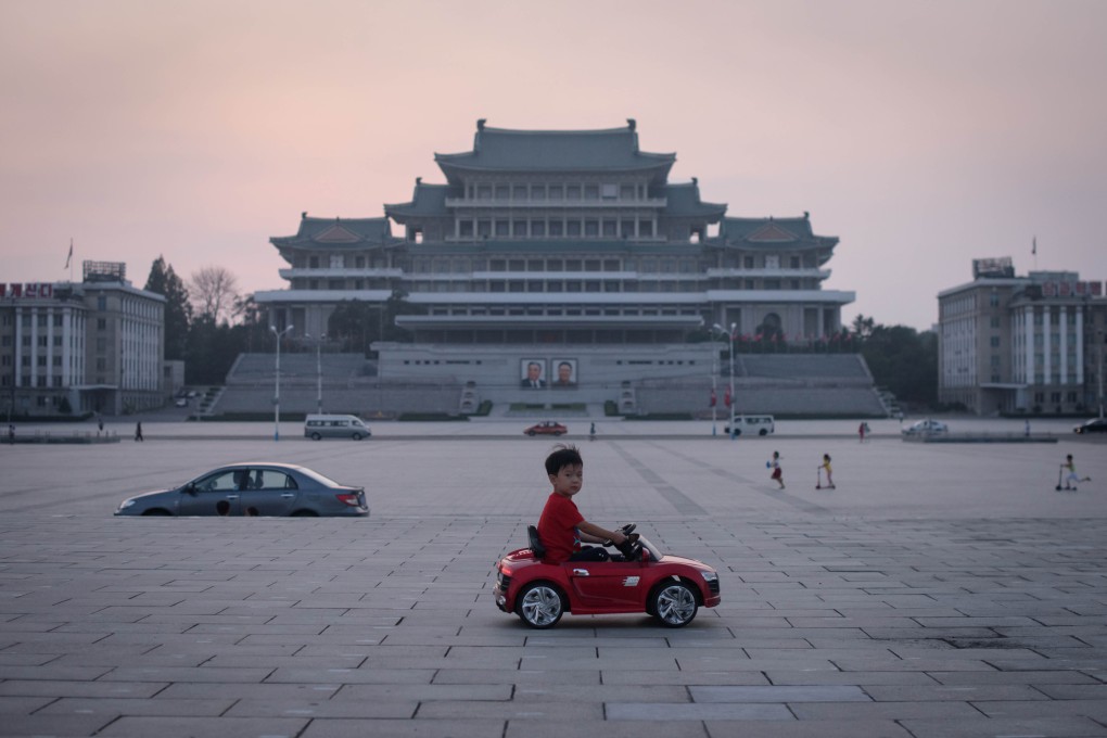 A child drives an electric toy car across Kim Il-sung Square in Pyongyang in September. Photo: AFP