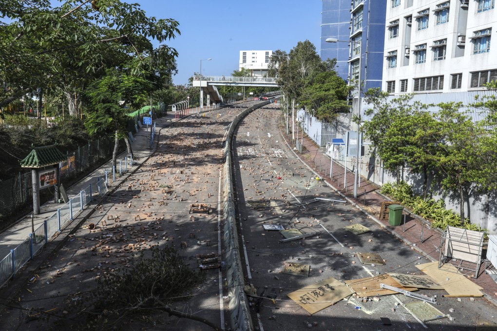 Roads near City University dormitories in Kowloon Tong are strewn with bricks and other obstacles during a protest. Photo: May Tse