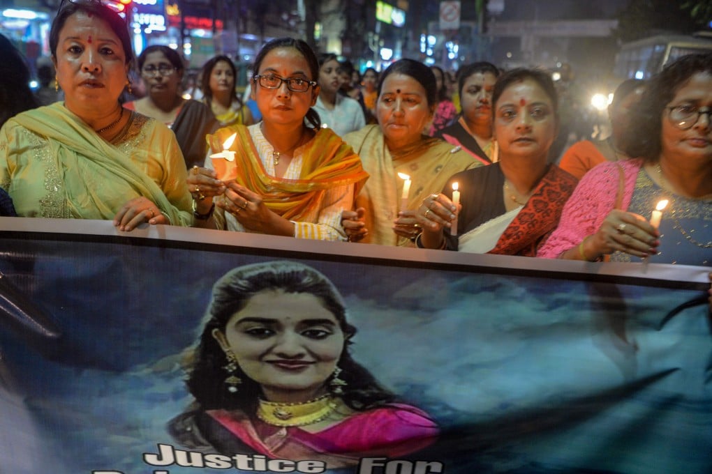 Protesters hold candles and a banner as they participate in a candle light procession calling for justice following the recent rape and murder case of a 27-year-old veterinary surgeon in Hyderabad, India. Photo: AFP