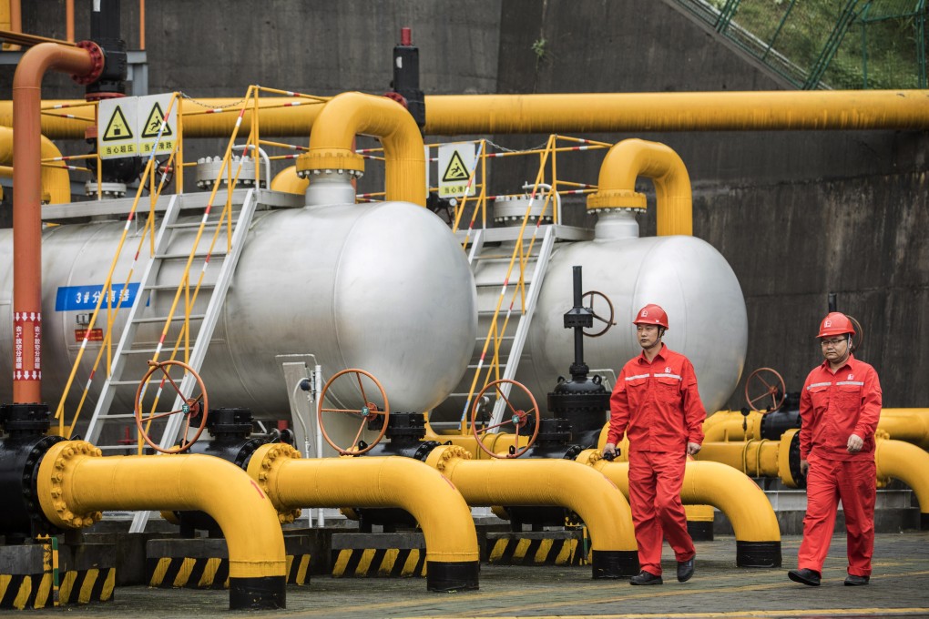 China needs to involve state-owned and private companies in policy making to better address major global problems like climate change. Here, workers walk past pipework and storage tanks at a project operated by Sinopec Chongqing Fuling Shale Gas Exploration and Development a unit of China Petrochemical Corp. Photo: Bloomberg