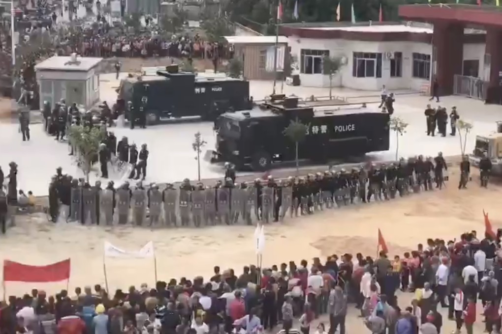 Police in Wenlou use armoured vehicles to keep protesters away from the town’s government building. Photo: Handout