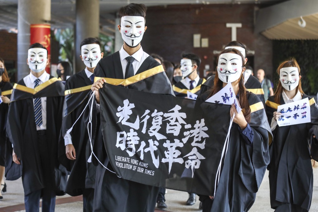 Polytechnic University students wear Guy Fawkes masks and chant slogans before their graduation ceremony on November 5. Photo: Dickson Lee