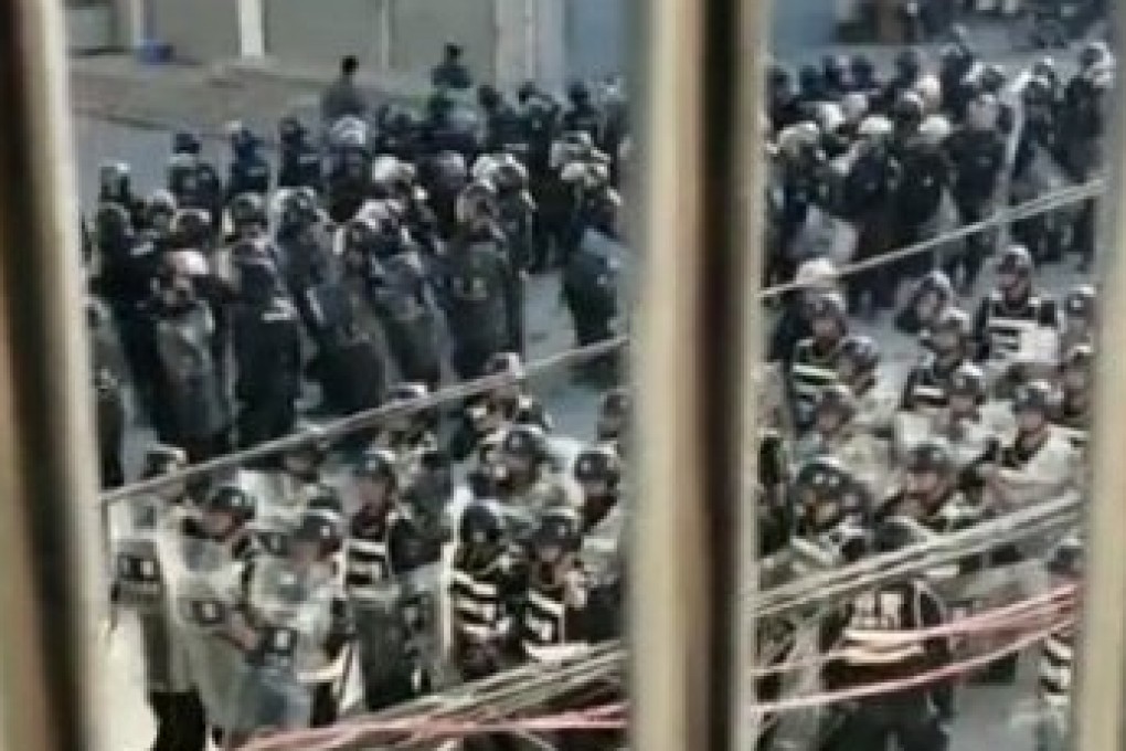 Riot police take up position in Wenlou in Guangdong province, after protests erupted in the township. Photo: Handout