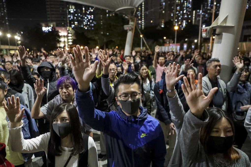 Democracy supporters raise their hands in support of the “five demands” of the protest movement at Wong Tai Sin Plaza on November 30. Photo: Edmond So