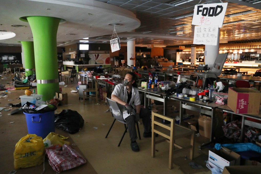 A protester who calls himself “Riot Chef”, and who says he was a volunteer cook for protesters, sits in a canteen in PolyU. Photo: Reuters/Leah Millis