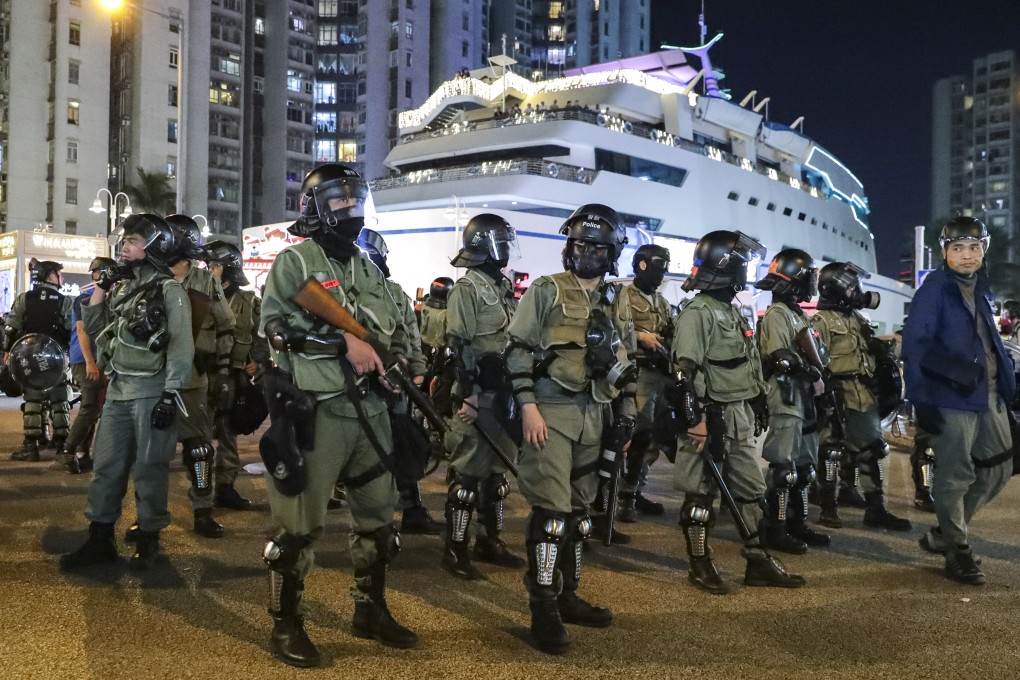 Riot police appear on the scene as anti-government protesters vandalise shops in Whampoa. Photo: Edmond So