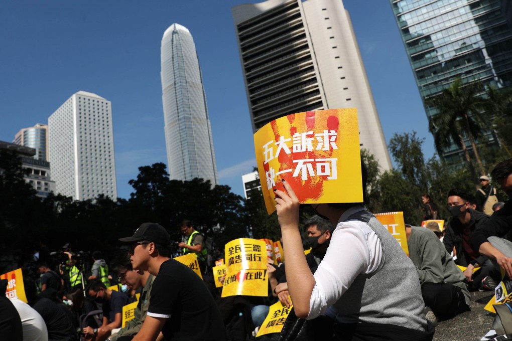 One worker holds a pro-democracy placard at the rally on Monday. Photo: Sam Tsang