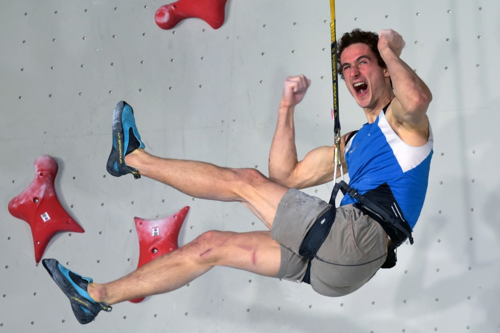 Adam Ondra celebrates during the speed climbing event at the Olympic qualifiers. Photo: AFP