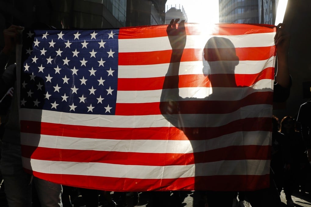 A US flag carried by a protester in Hong Kong. Photo: AP
