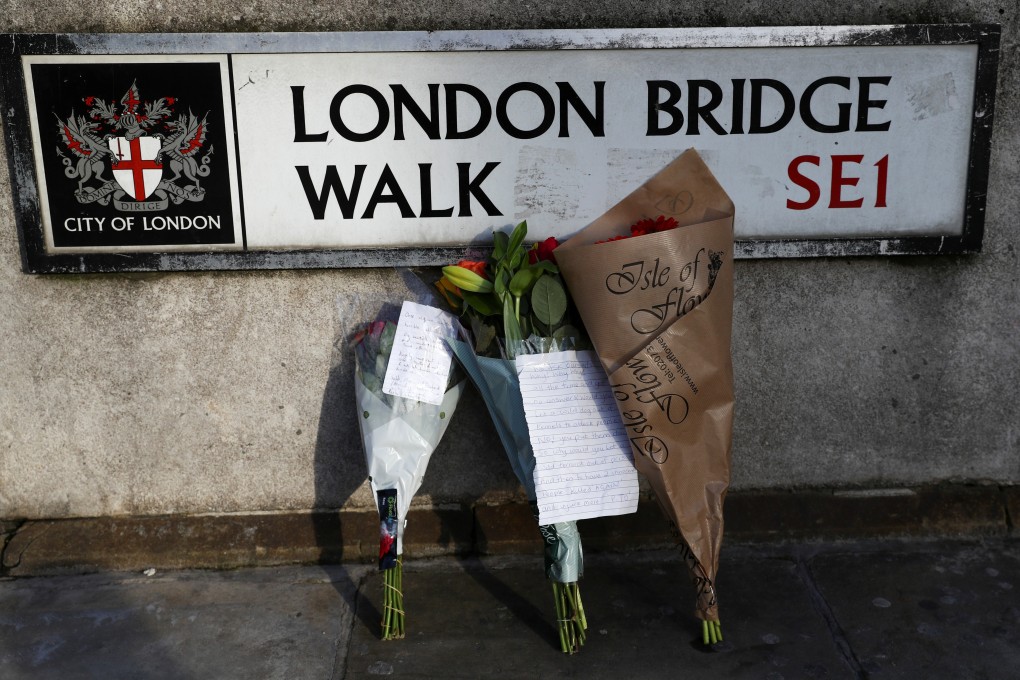 Flowers are left at the scene of knife attack near London Bridge in which two people were killed. Photo: Reuters
