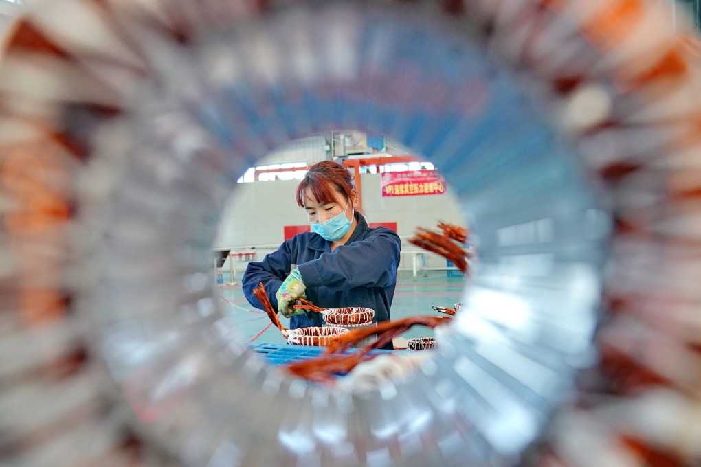 An employee works at an electromechanical equipment company in Kaiping, in Hebei province. Manufacturing activity has edged up in China and the United States. Photo: Xinhua