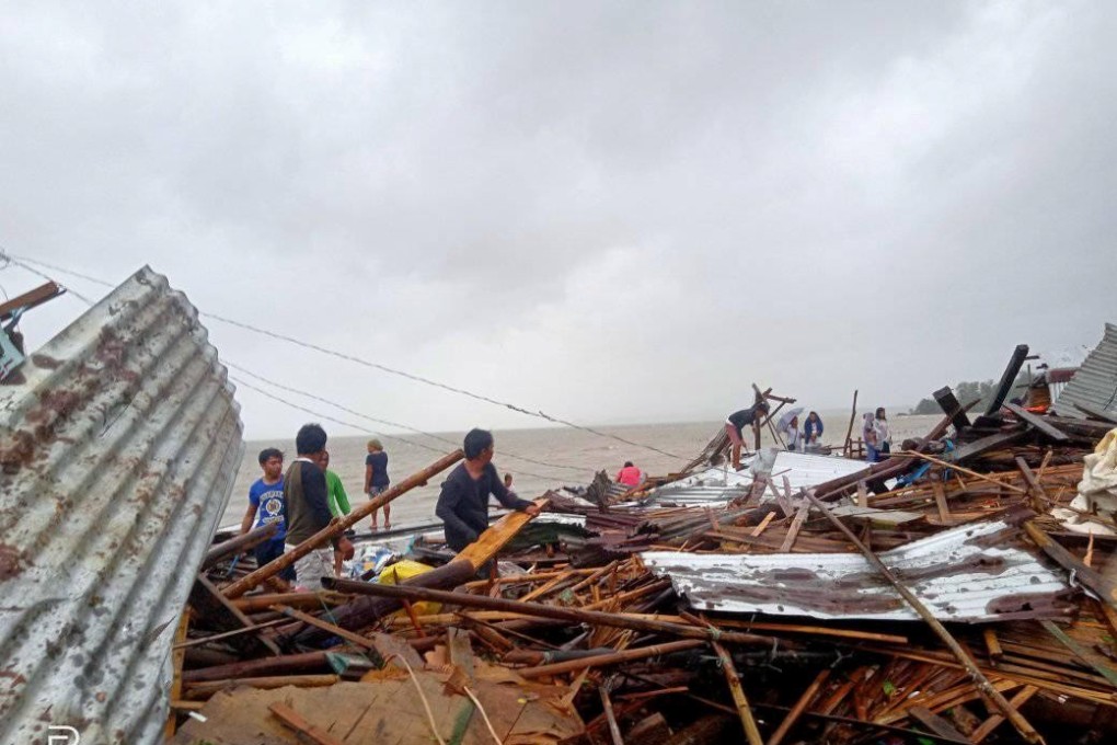 Residents stand among their destroyed houses after Typhoon Kammuri hit Sorsogon Province in the Philippines. Photo: Reuters