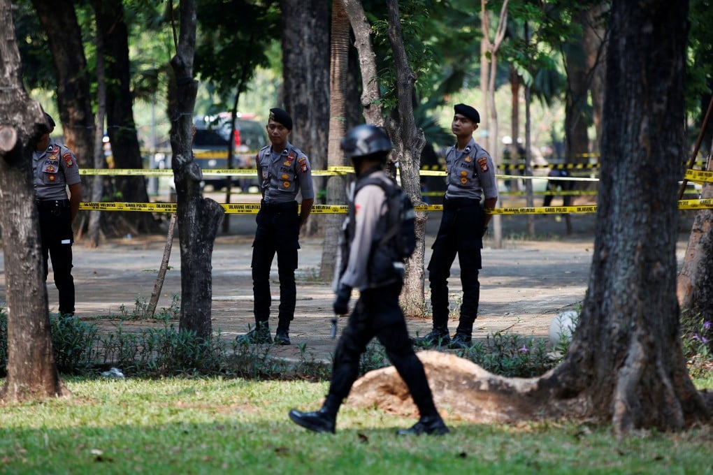 Indonesian police officers after the blast at the National Monument park in Jakarta. Photo: Reuters