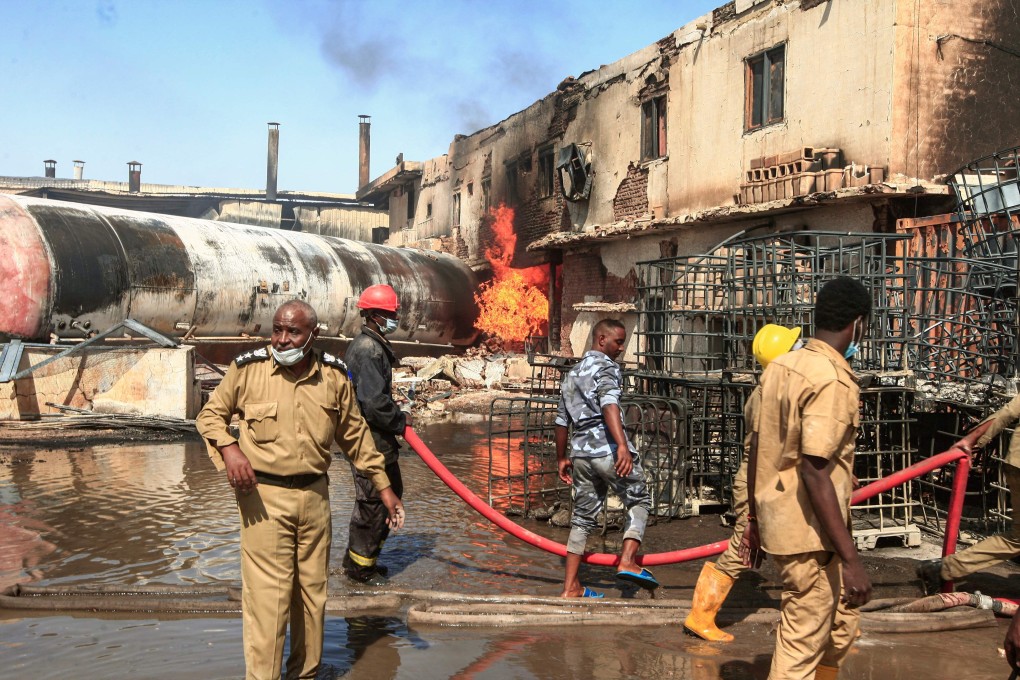 Members of the Sudanese Civil Defence put out a fire at a tile manufacturing unit in an industrial zone in north Khartoum. Photo: AFP