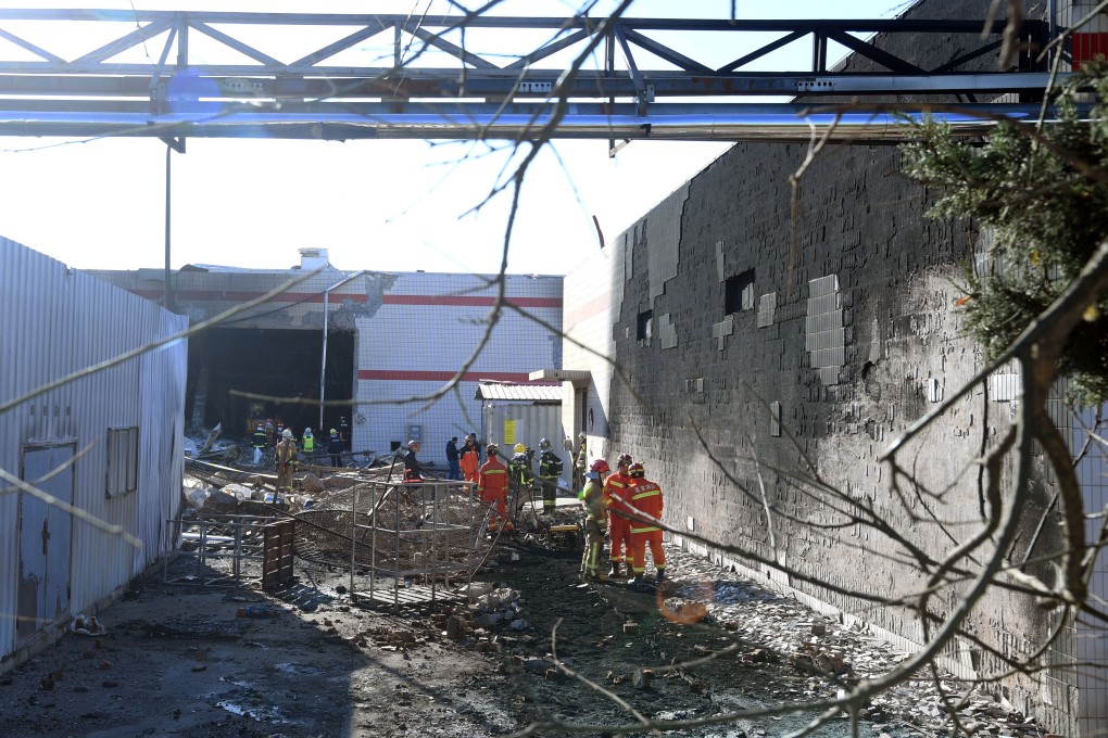 Firefighters assess the scene of a deadly factory explosion in northern Beijing on Tuesday. Photo: Xinhua