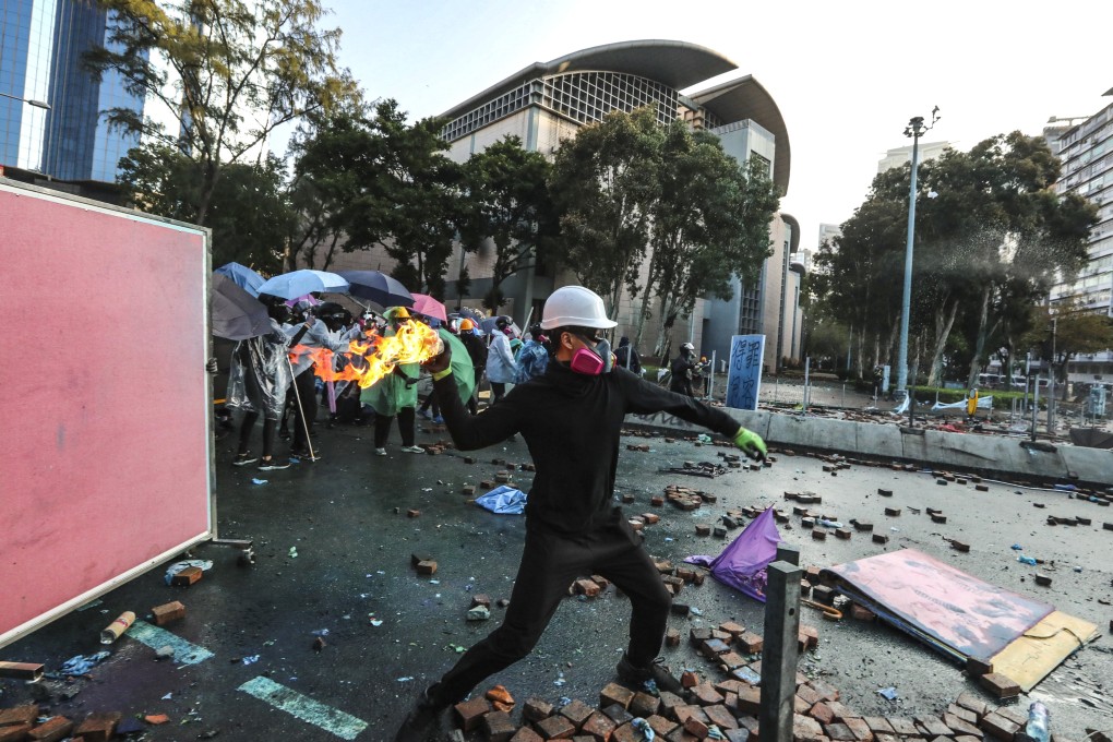 A protester throws a petrol bomb at police near Polytechnic University in Hung Hom on November 17. Photo: Felix Wong