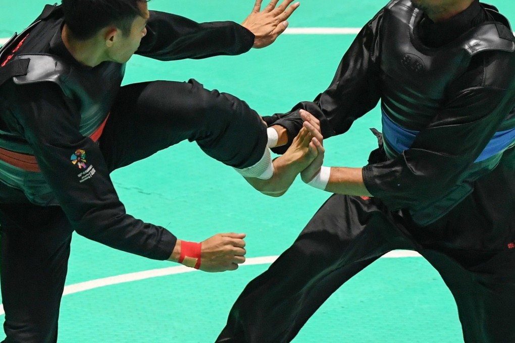 Action from the Pencak Silat at the Asian Games 2018 between Komang Harik Adi Putra (left) of Indonesia and Malaysia’s Mohd Al-Jufferi Jamari. Photo: Xinhua