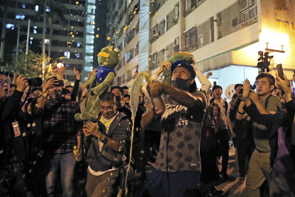 Pro-democracy supporters celebrate after pro-Beijing politician Junius Ho lost his election in Hong Kong,. Photo: AP