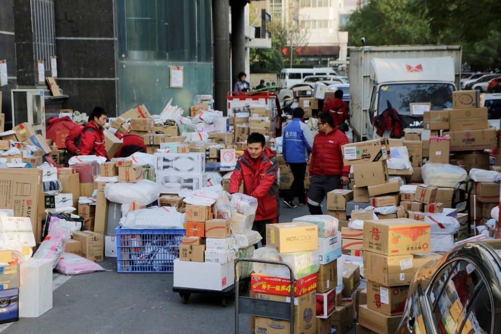 Deliverymen work among parcels beside a road in Beijing on November 12, following the Singles’ Day shopping blitz. China’s labour market has stayed resilient, despite external shocks to the economy. Photo: Reuters