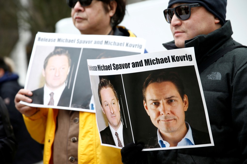People hold signs calling for China to release Canadian detainees Michael Spavor and Michael Kovrig during an extradition hearing for Huawei Technologies Chief Financial Officer Meng Wanzhou earlier this year. Photo: Reuters