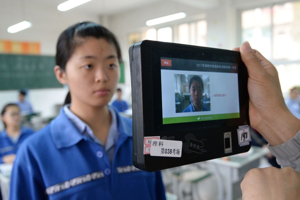 Both fingerprint and facial recognition technology are used in this device to check the identification of a student in China. Photo: AFP