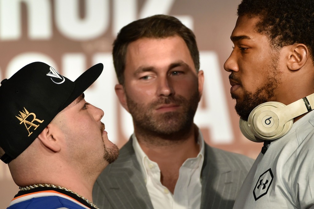 Andy Ruiz Jnr (left) and Anthony Joshua (right) face each other, as promoter Eddie Hearn (centre) looks on. Photo: AFP