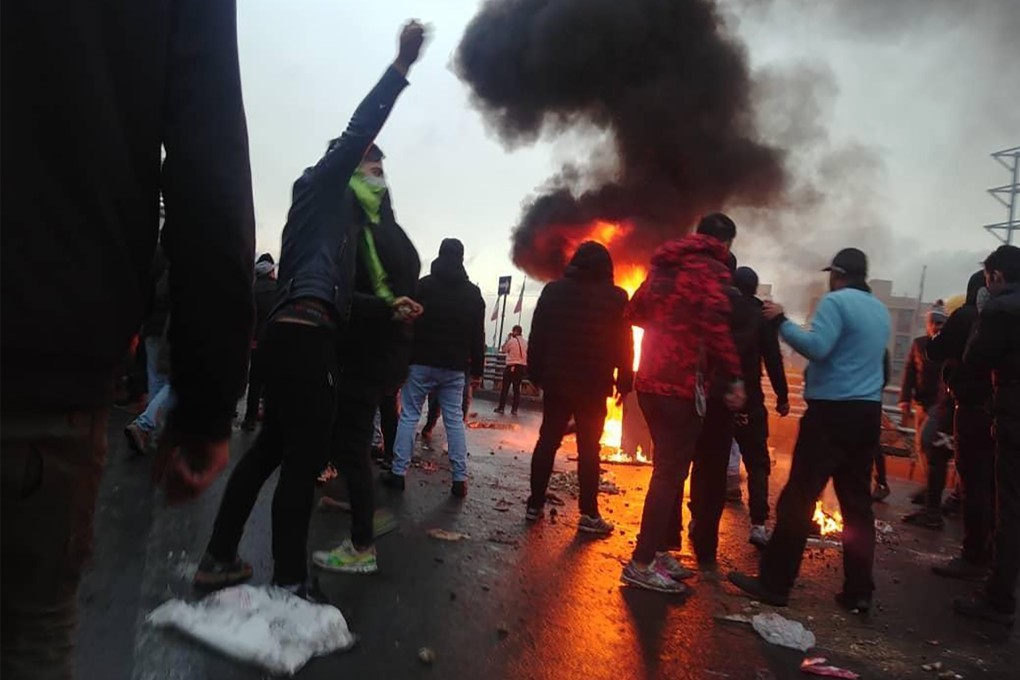 Iranian protesters gather around a fire in Tehran in November during a demonstration against an increase in petrol prices. Photo: AFP