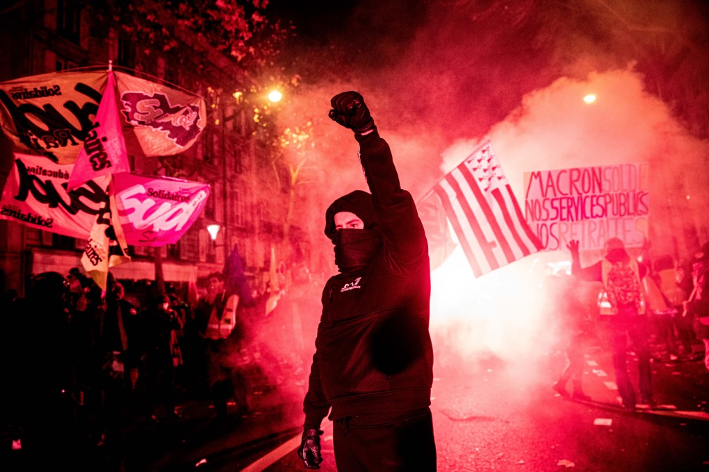 A demonstrator raises a fist while protesting during a national strike in Paris on Thursday. Photo: Bloomberg