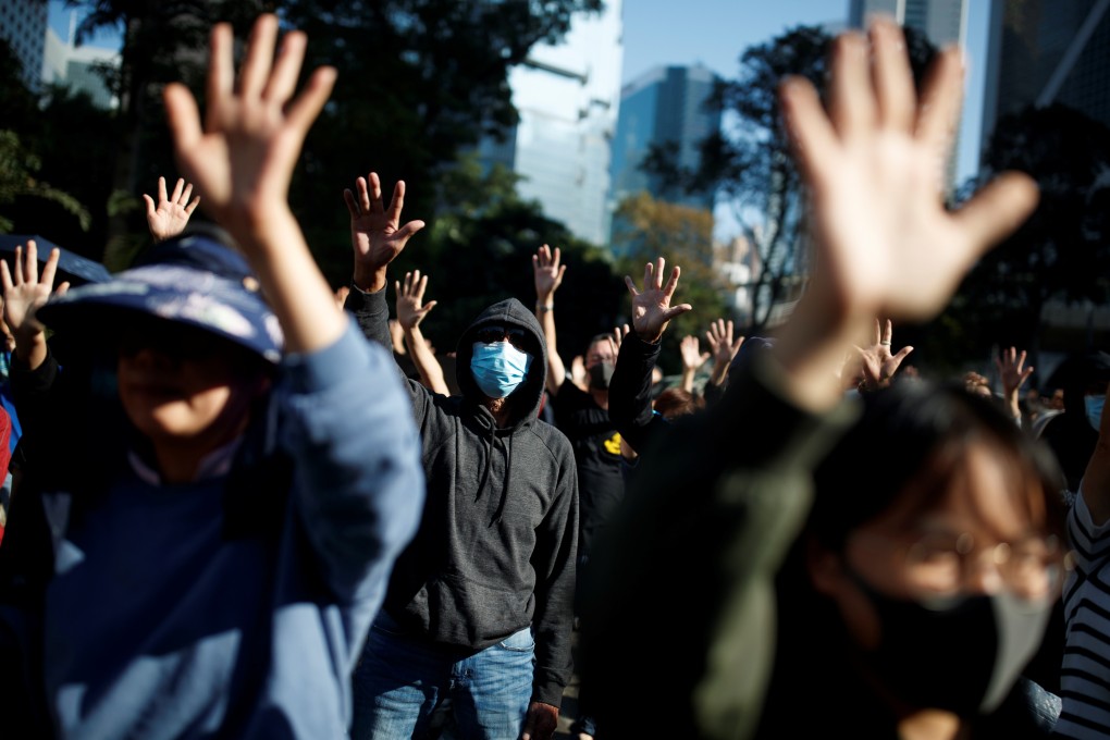People raise their hands as they sing the protest anthem “Glory to Hong Kong” during an anti-government protest in the Central district of Hong Kong on November 30. Photo: Reuters