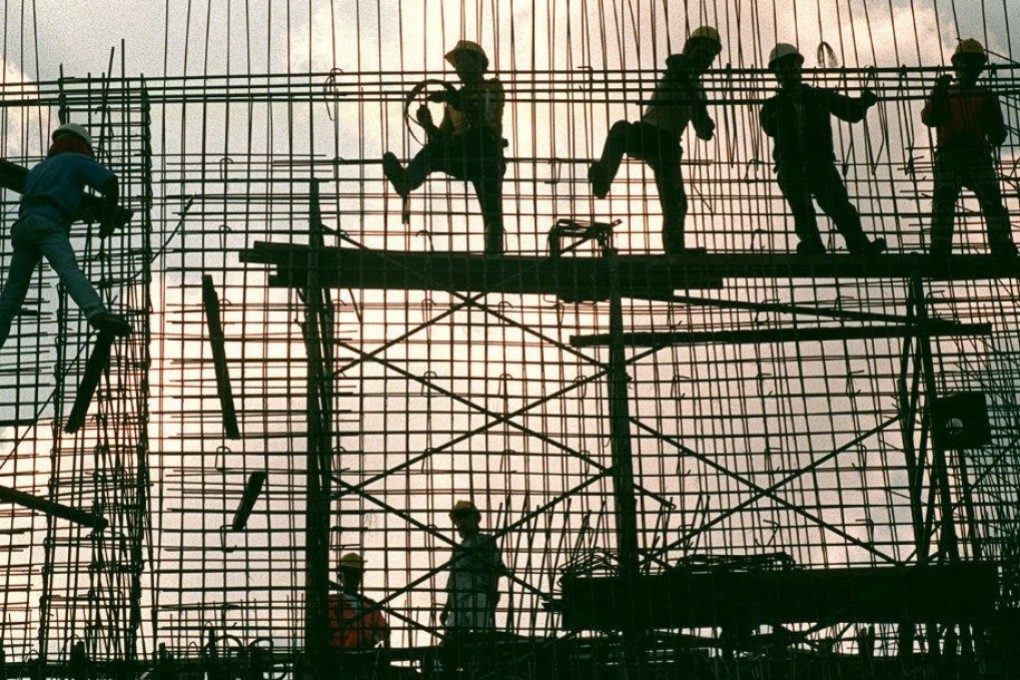 Workers erect a reinforcement grid of iron bars for a concrete wall of a power substation in Manila. Photo: AFP