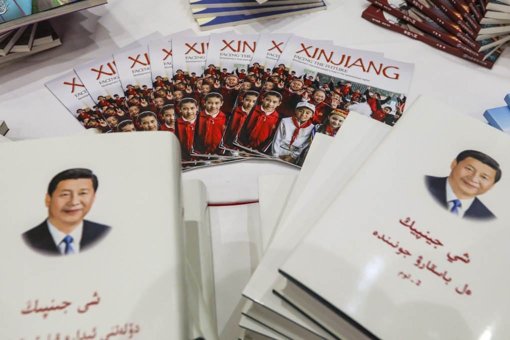 Books by Chinese President Xi Jinping in the Uygur language, left, and Kazakh language, right, are displayed at an official press conference on the issues of “building a beautiful Xinjiang, jointly realising the Chinese dream”, in Beijing on July 30. Photo: Simon Song