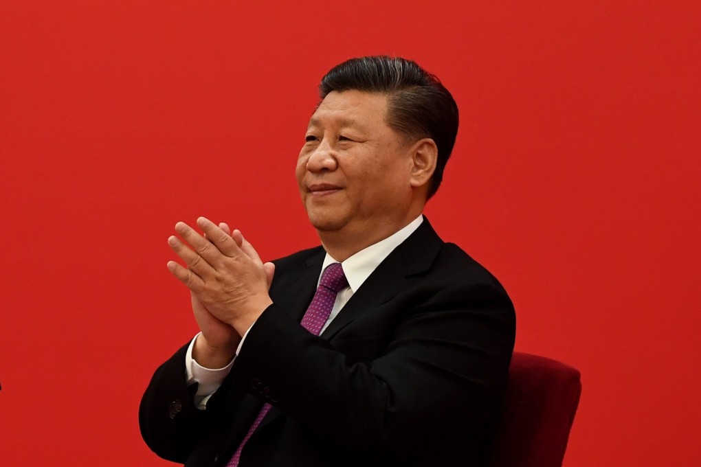 China's President Xi Jinping claps as he listens to Russian President Vladimir Putin. Photo: EPA