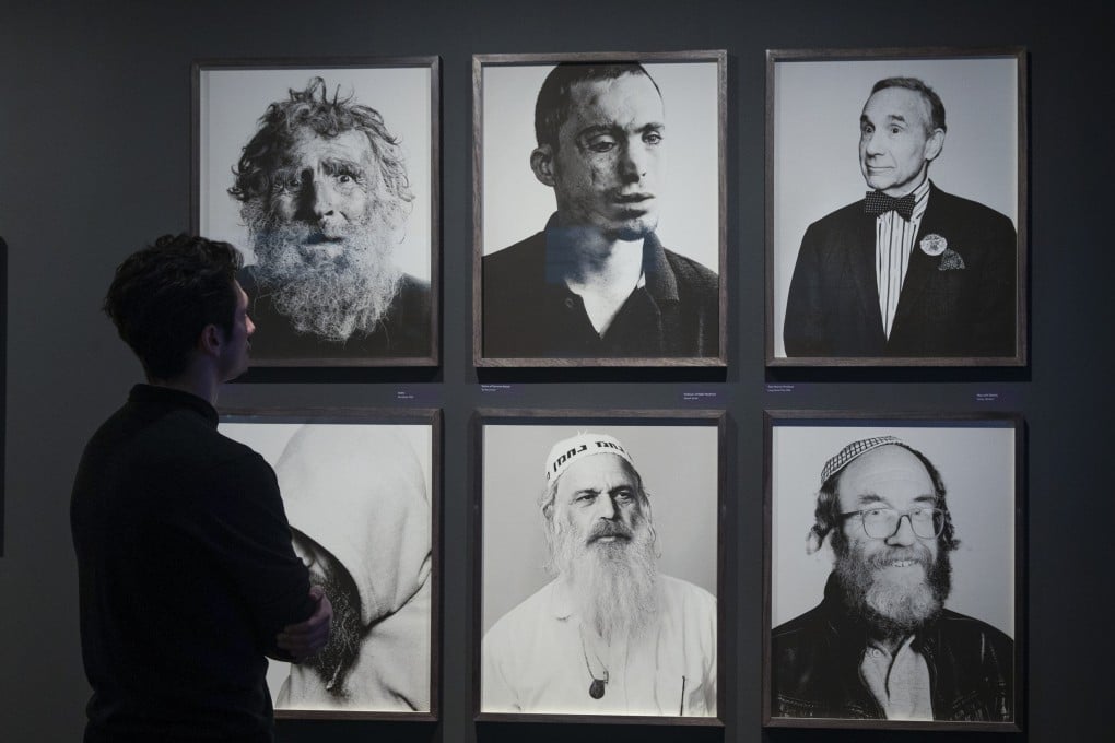 A visitor to photographer John Offenbach’s exhibition JEW at the Jewish Museum in Camden, north London. The show, which includes portraits of Jews in Kaifeng, central China, explores what it means to identify as Jewish today. Photo: Mark Thomas Photography