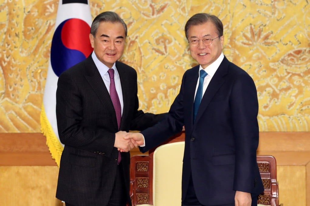 Chinese Foreign Minister Wang Yi is greeted by South Korean President Moon Jae-in. Photo: Reuters