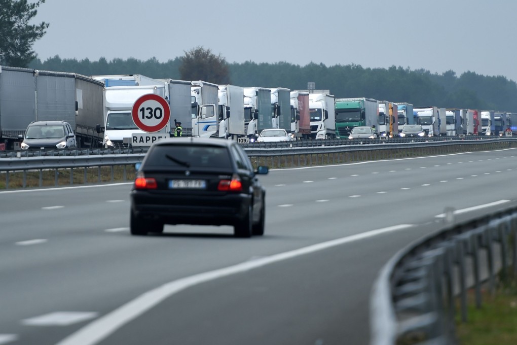 Trucks block the A63 highway during a national strike over a planned rise of fuel taxes for haulage companies, joining another strike over pension reforms. Photo: AFP