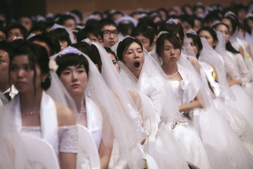 A bride yawns in a mass wedding ceremony at the Cheong Shim Peace World Center in Gapyeong. Photo: AP