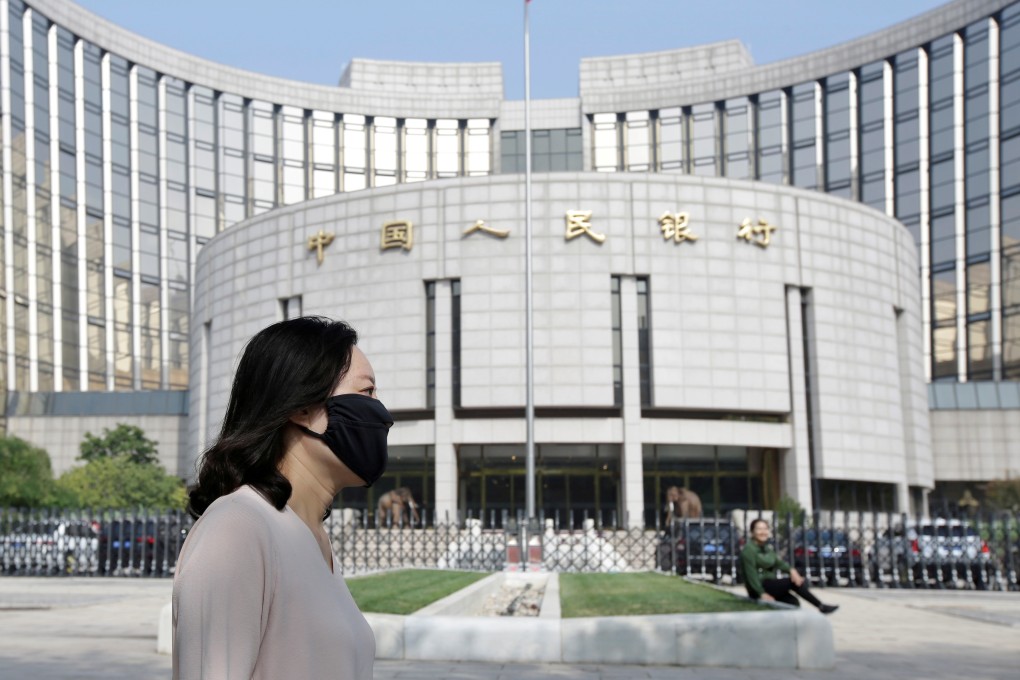 A woman walks past the headquarters of the People’s Bank of China in Beijing on September 28, 2018. China’s central bank made a number of small rate cuts in November this year, easing fears that it was constrained in delivering monetary stimulus. Photo: Reuters