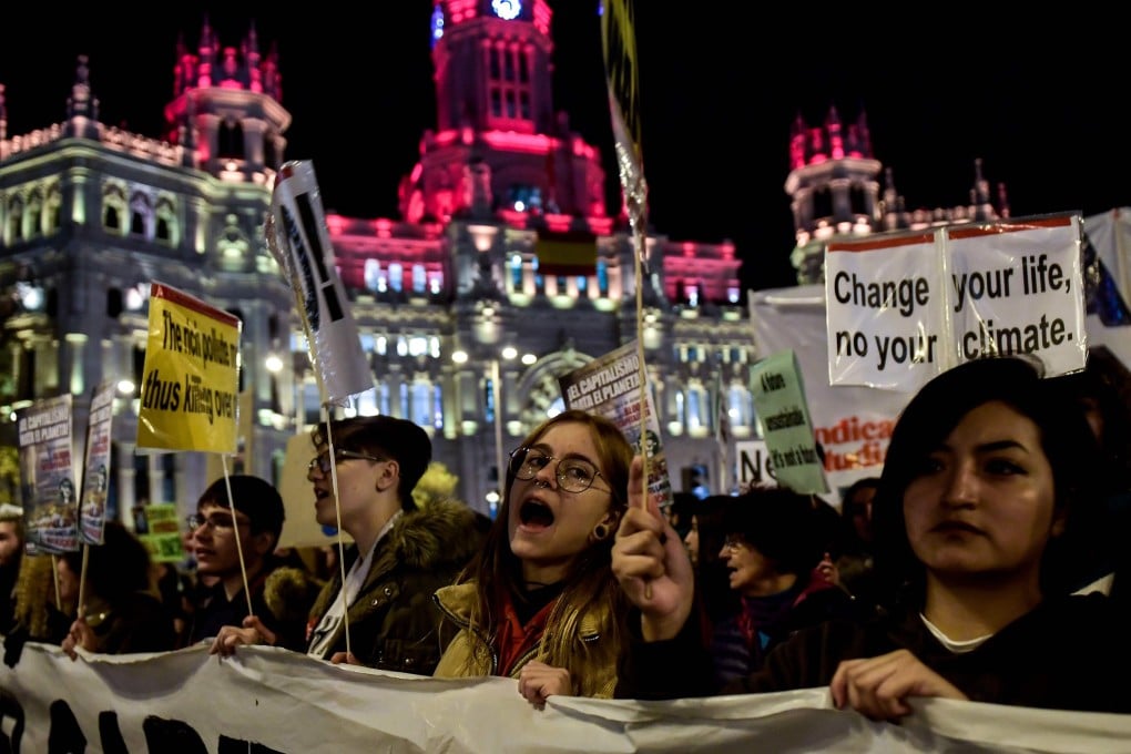 Demonstrators walk past the city hall in Madrid during a mass climate march to demand urgent action on the climate crisis. Photo: AFP