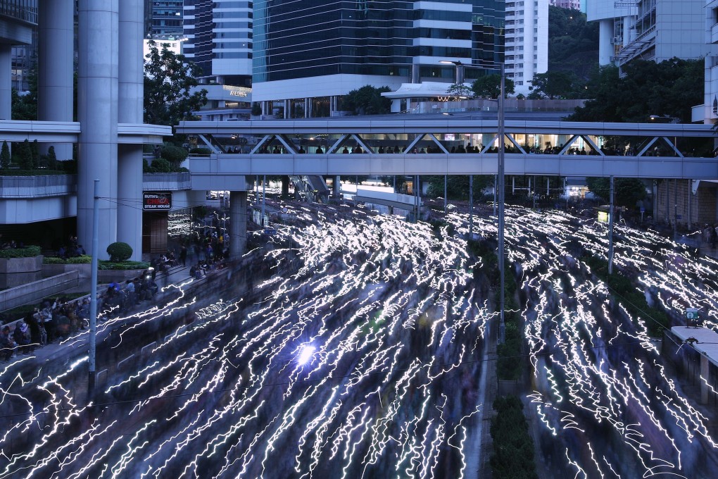 Hong Kong protesters used their smartphones to create a streaming flow of light in the streets. Photo: Sam Tsang