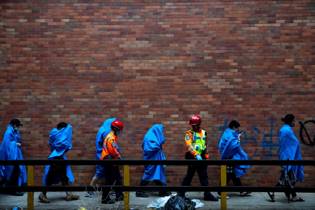 Protesters leave the Kong Polytechnic University campus on November 19, after an over 10-day long siege. Photo: Reuters