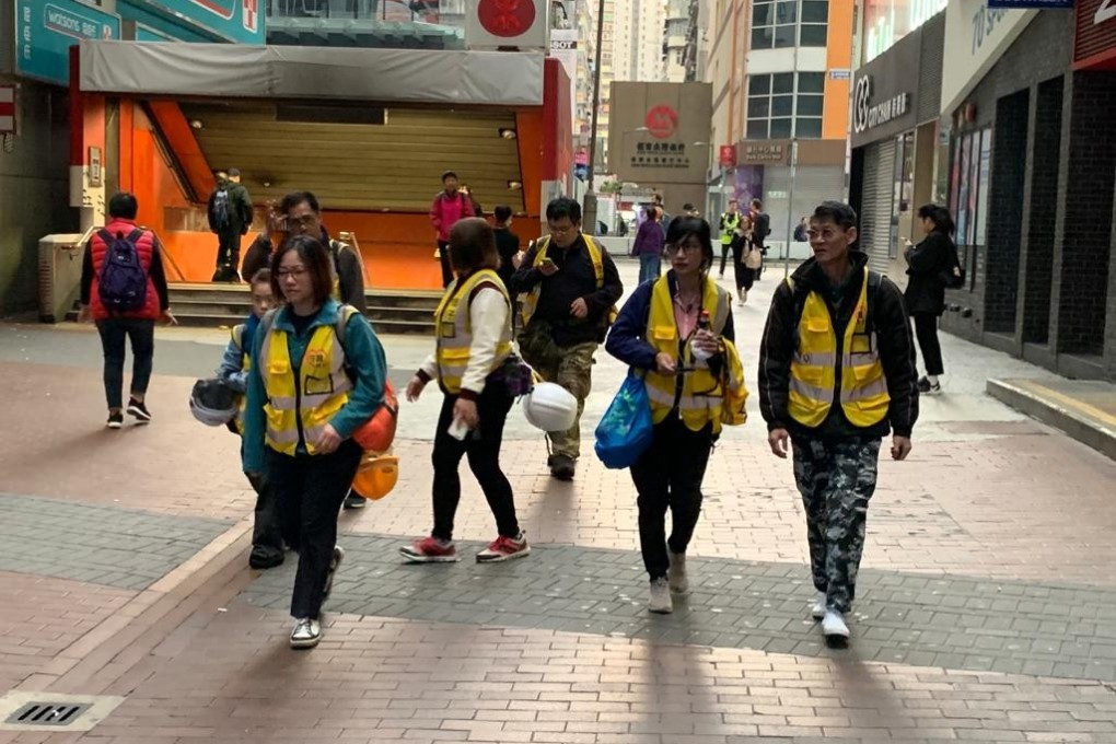 Seven members of ‘Protect the children’, a group of adult and elderly volunteers in yellow vests who usually stand on the front line to urge restraint from police during clashes, fail to find any protesters in Mong Kok. Photo: Victor Ting