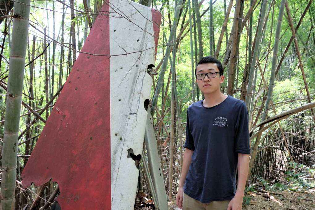 Felix Wong, a Hong Kong-born Canadian, in a jungle in Suphanburi, Thailand, beside a vertical stabiliser that belonged to the Lauda Air Flight 004 plane that crashed on its way from Hong Kong to Vienna in 1991. His aunt was among the 223 people killed. Photo: Tibor Krausz