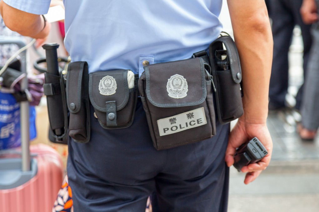 A police officer in Baoding, Hebei province, says his boss told him and an auxiliary officer to take official responsibility for a suicide of a suspect in detention last year. Photo: Getty Images
