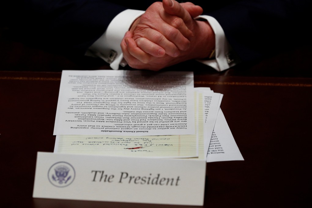 A hand written draft of a tweet for US President Donald Trump about the report of Justice Department Inspector General Michael Horowitz is seen in front of the president. Photo: Reuters