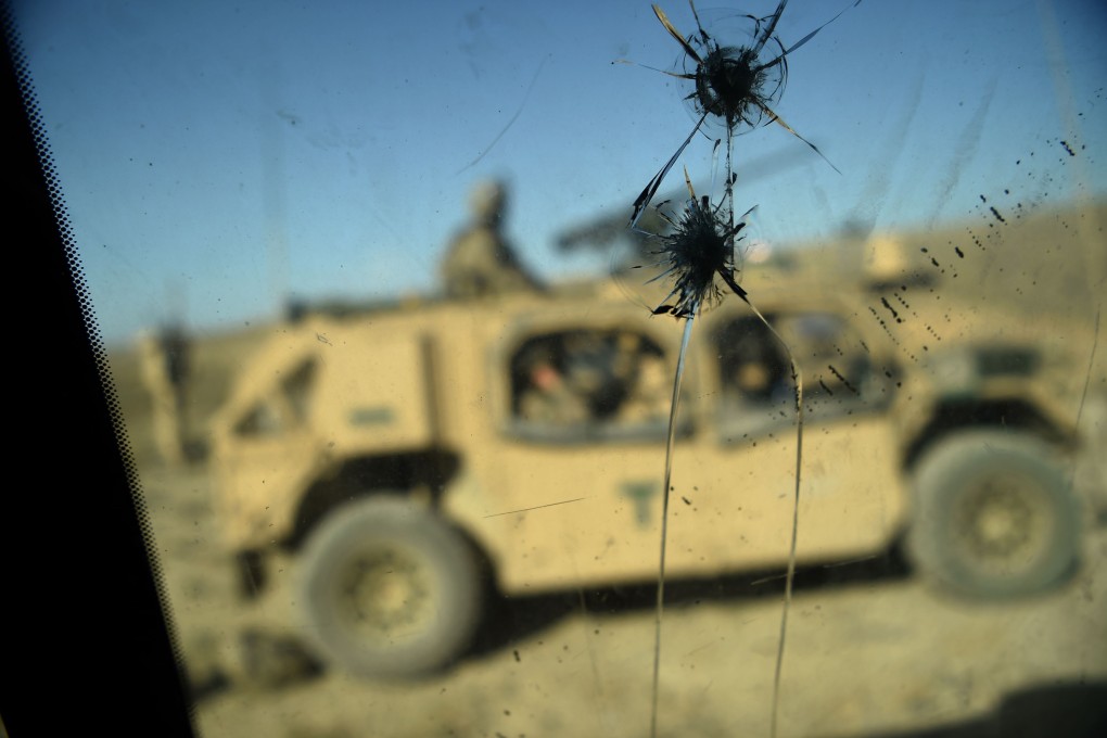 US soldiers who are part of the Nato deployment are seen through the cracked window of an armoured vehicle in Afghanistan’s Nangarhar province in July 2018. US retrenchment in Afghanistan was a campaign promise by President Donald Trump. Photo: AFP